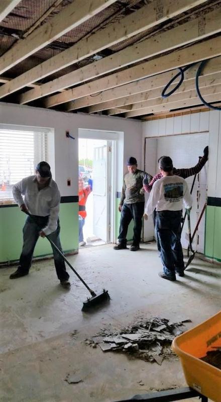 Workers repair Classroom 1 at Kreative Kids Academy, after their building was heavily damaged.